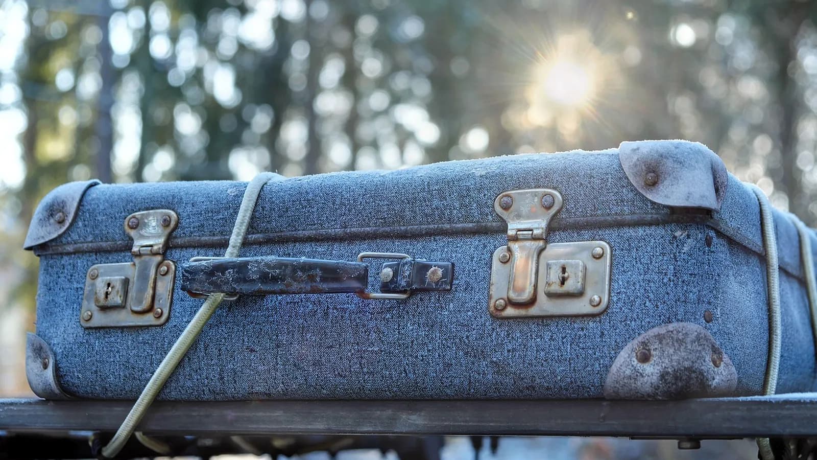 A vintage suitcase in a winter setting