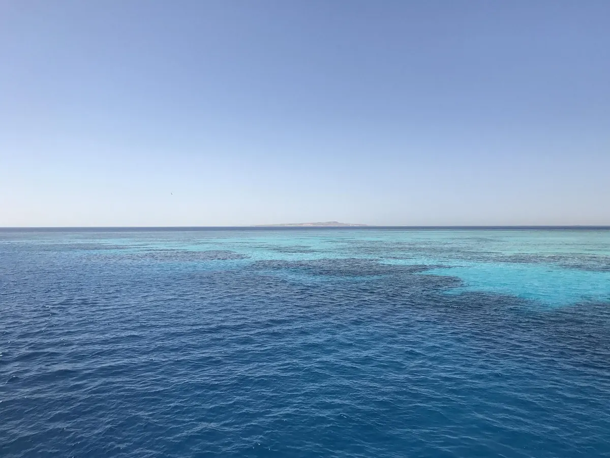 A dive boat over a Red Sea reef