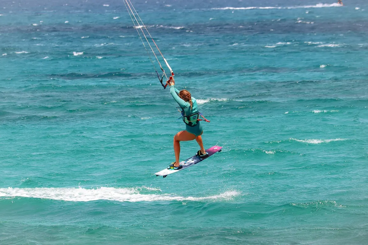 A kitesurfer on a turquoise lagoon