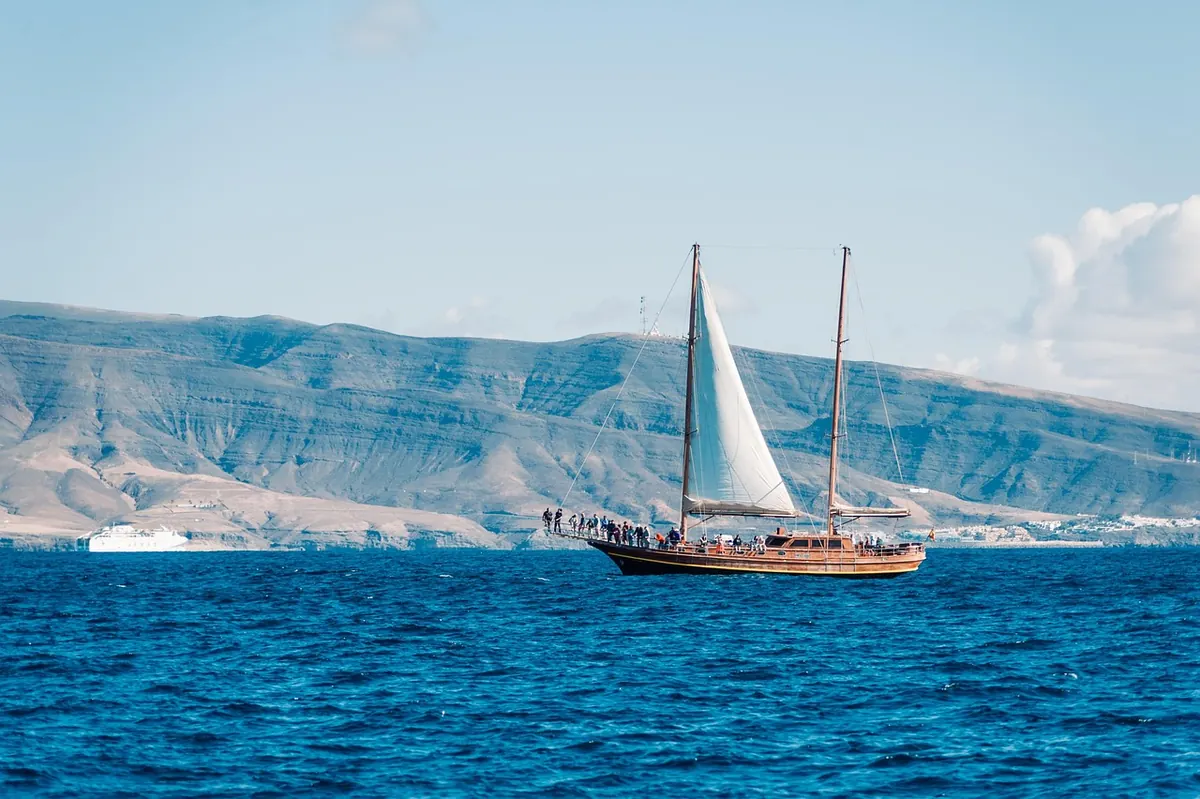 A sailing boat off a desert island