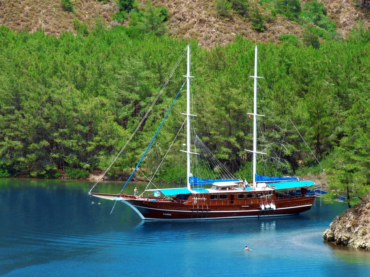 A wooden gulet in a pine-fringed Turkish bay