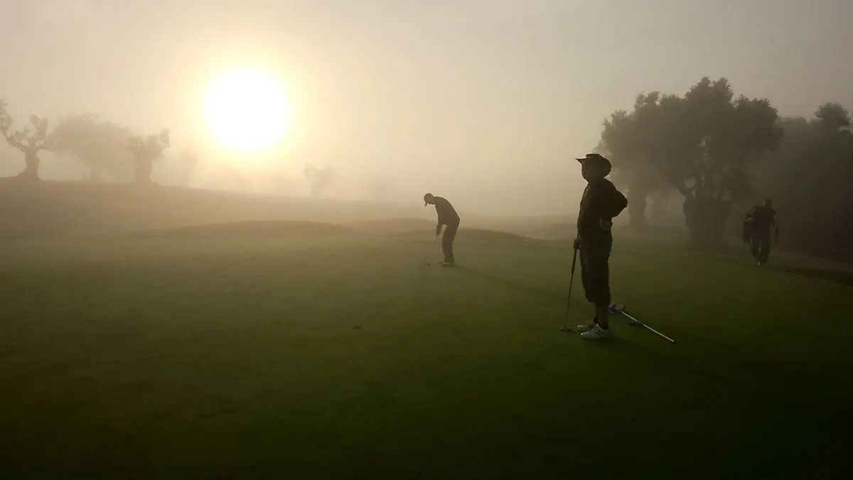 Golfers on a misty morning in the Algarve