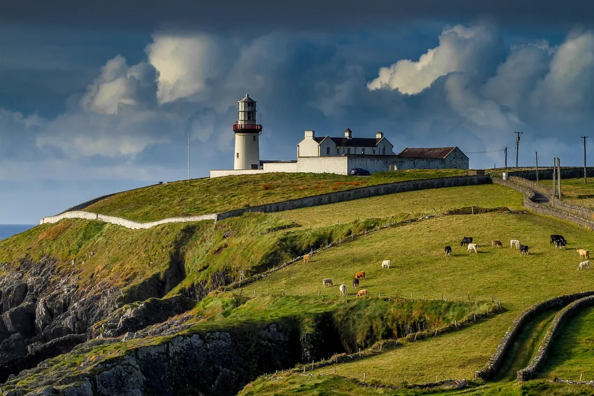 A lighthouse on a headland on the Irish coast