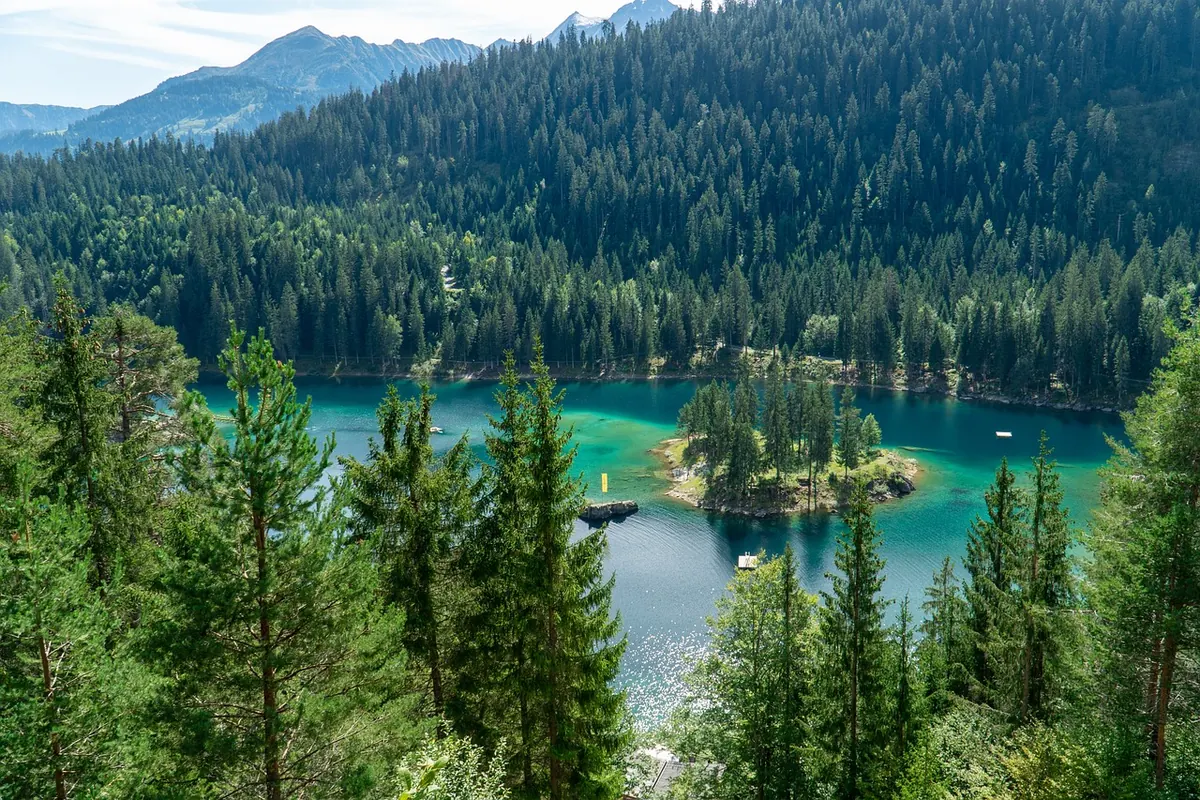The turquoise Caumasee in the forest above Flims