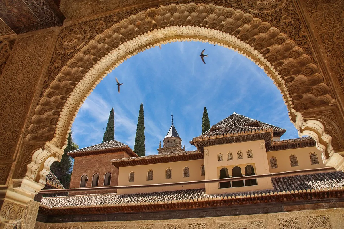 The Alhambra framed by a Moorish arch