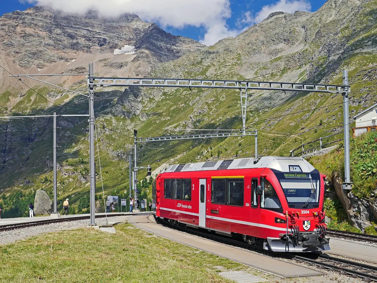 A red Rhaetian Railway train in the Swiss Alps
