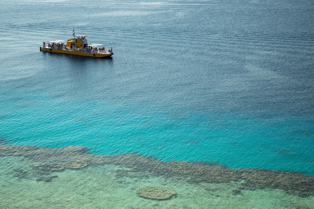 A boat moored over a Red Sea reef