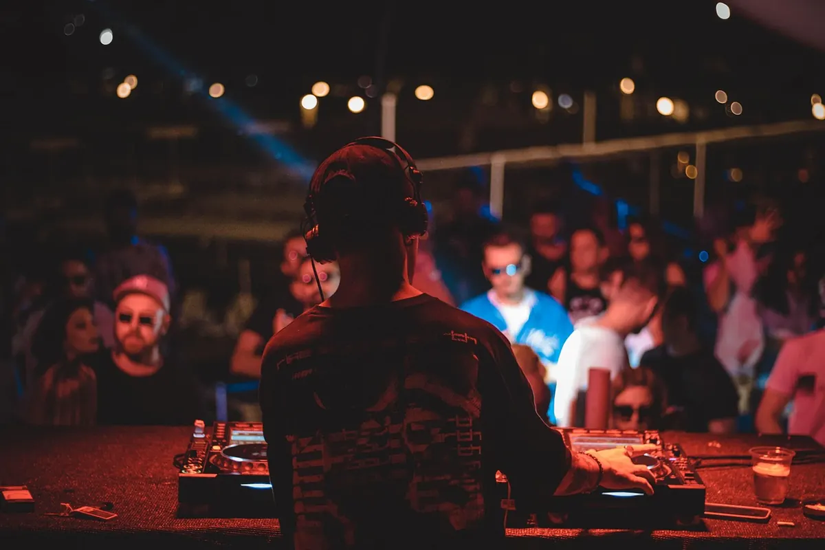 A DJ playing to a crowd at night