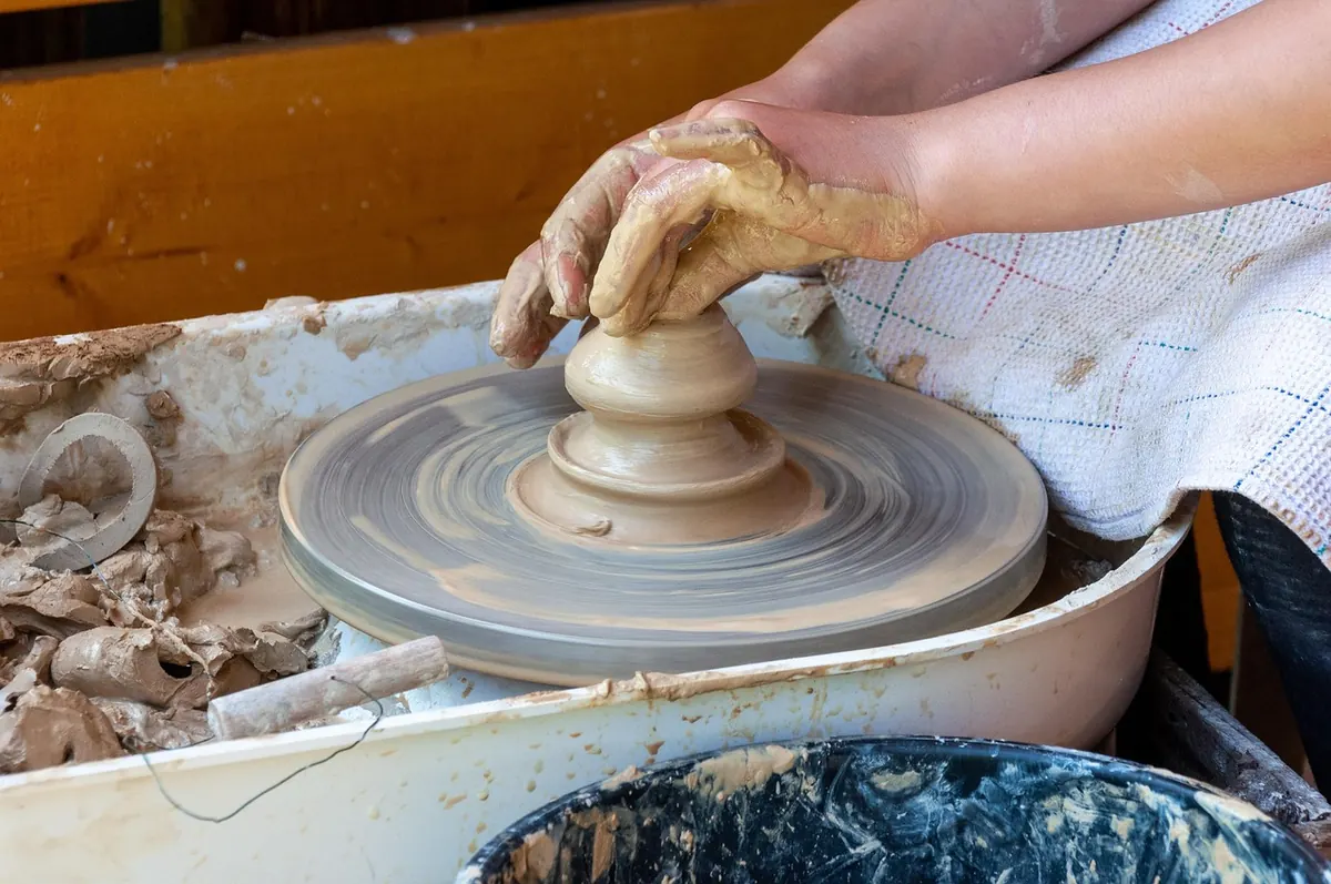 Shaping clay on a potter's wheel