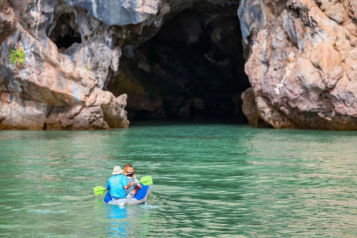 A kayaker paddling into a sea cave