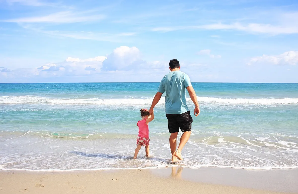 A father and daughter on the beach
