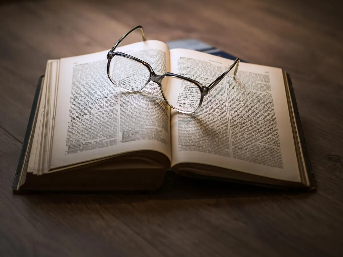 A guidebook and glasses
