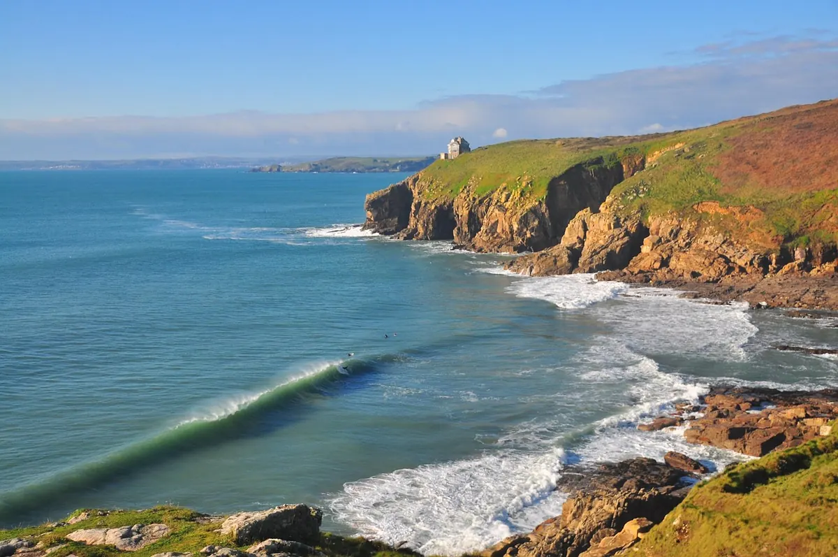 Surf rolling onto a beach in Cornwall