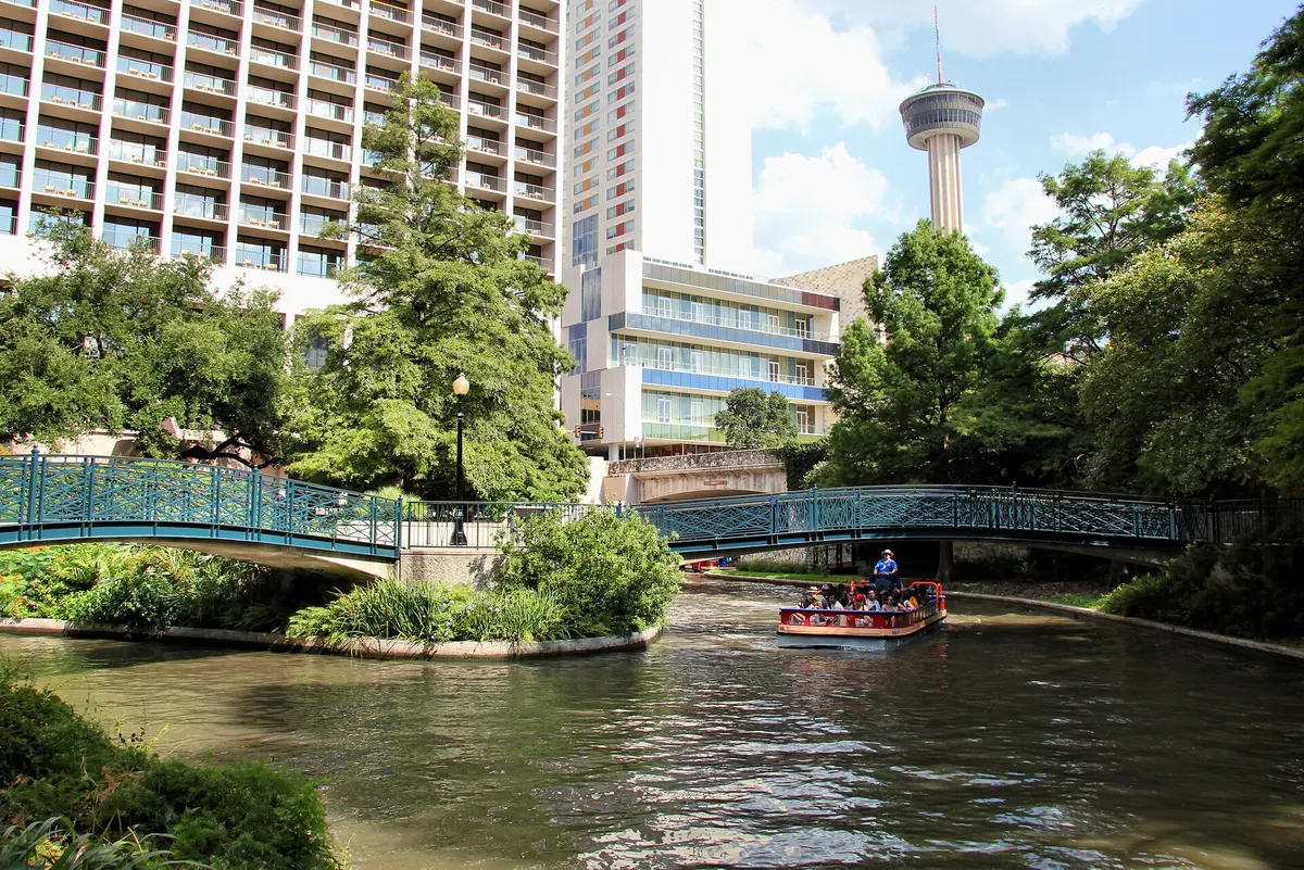 The River Walk in San Antonio with the Tower of the Americas