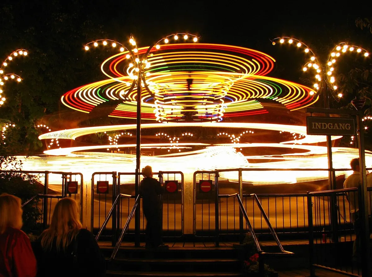 A carousel lit up at night in Tivoli Gardens, Copenhagen