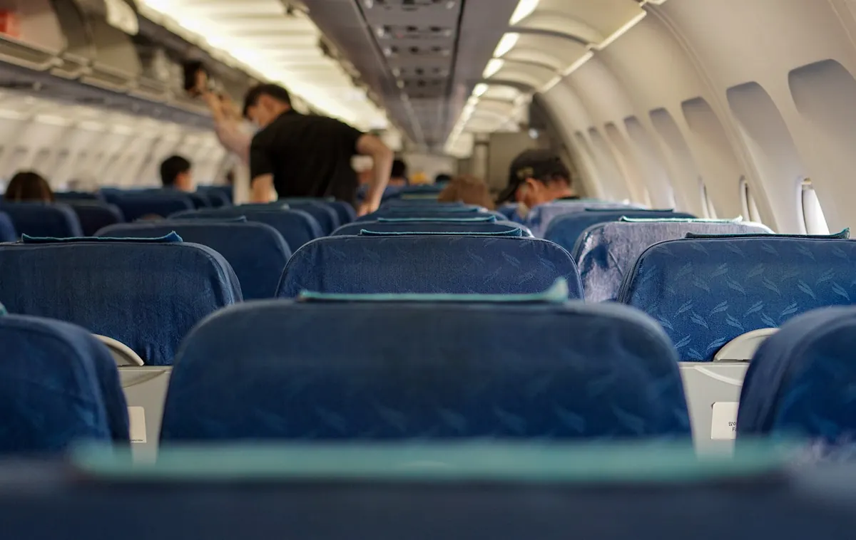 Rows of seats in an airliner cabin