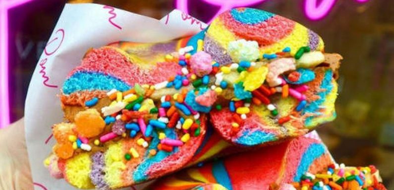 Insta-worthy rainbow bagels and pink hotdog buns on menu at vegetarian eatery