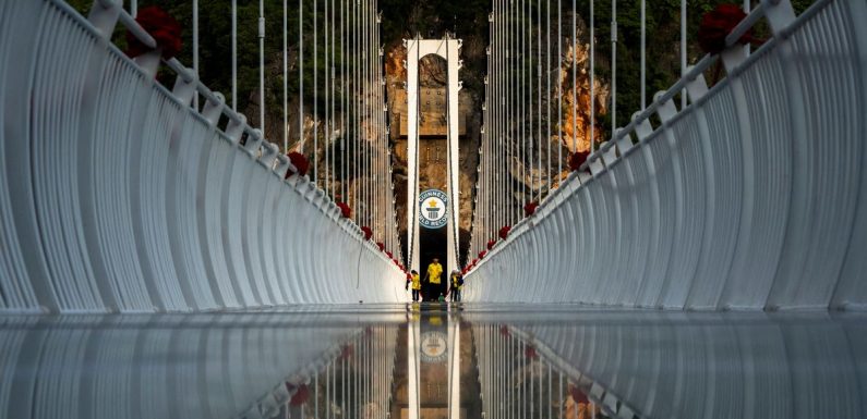 Tourists take snaps on terrifying record-breaking glass bridge 150m high