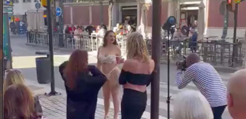 Models rip off clothes and bare breasts to gobsmacked locals in Costa del Sol
