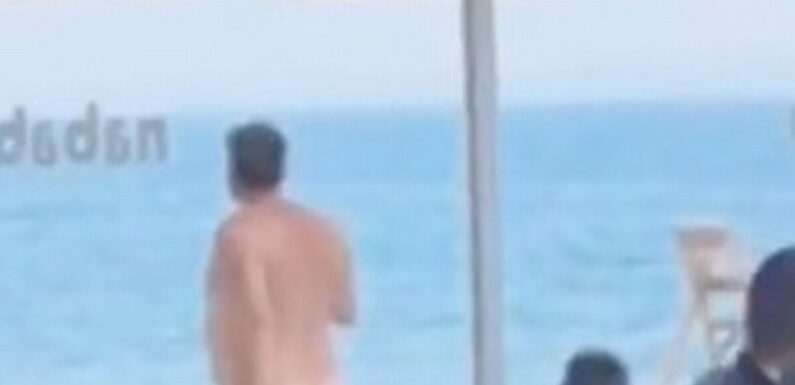 Benidorm tourists howl with laughter as naked man strolls through crowded beach